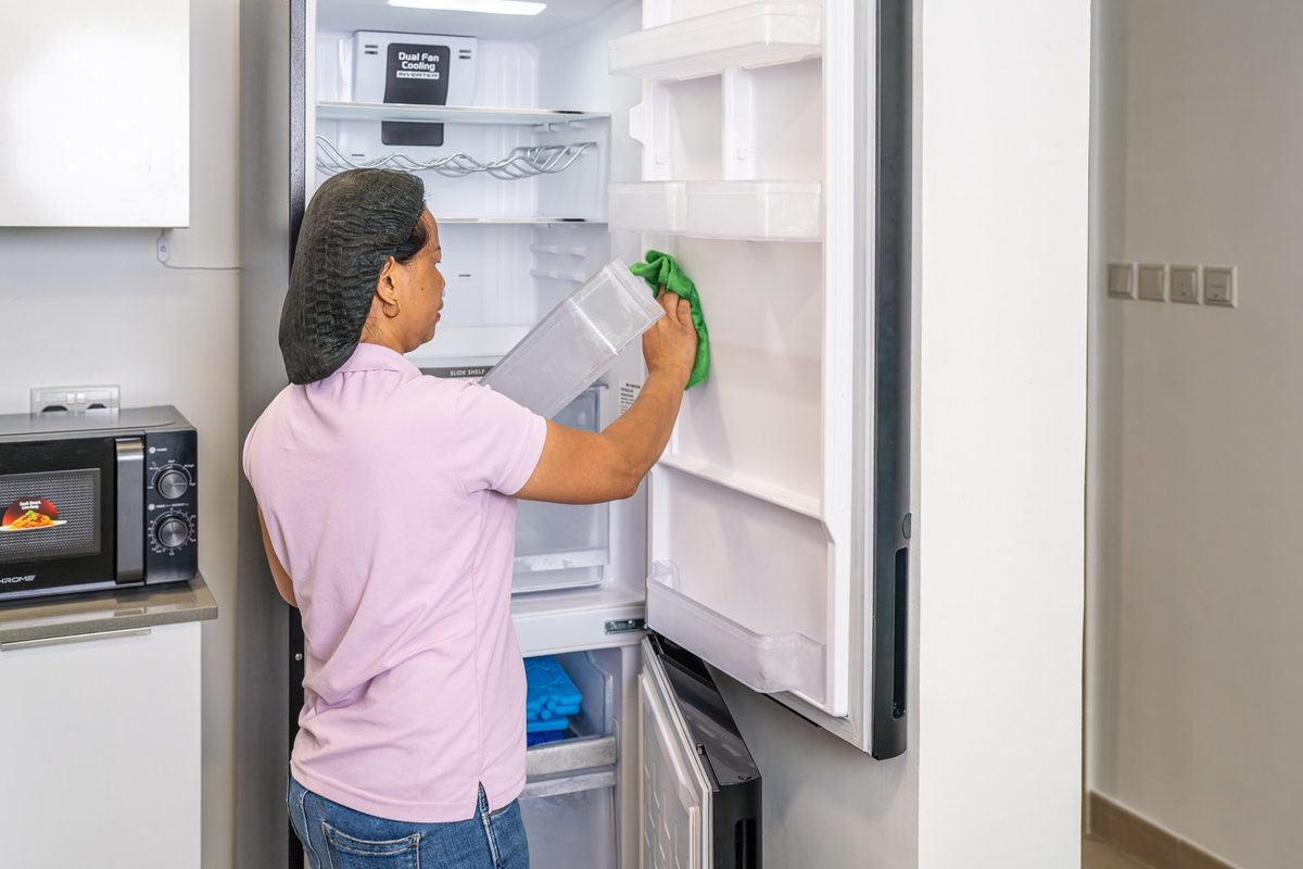 Cleaner wiping inside a refrigerator